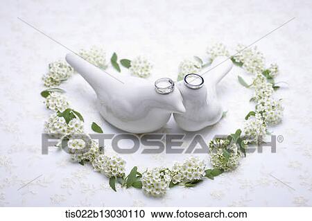 Clipart - wedding rings on porcelain birds. Fotosearch