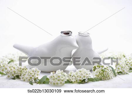 Stock Illustration - wedding rings on porcelain birds. Fotosearch