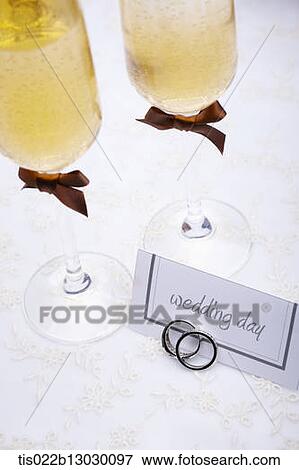 Stock Illustration - wedding rings with champagne. Fotosearch