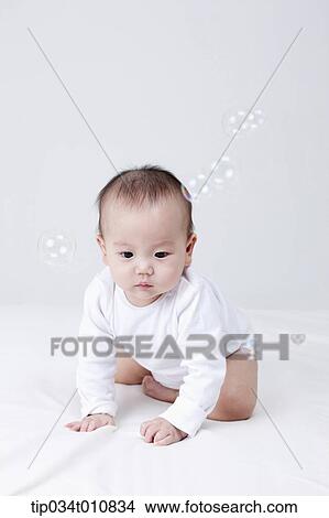 a baby and bubbles in the air View Large Photo Image Picture - a baby and bubbles in the air . Fotosearch