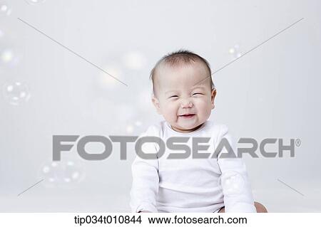 a baby and bubbles in the air View Large Photo Image Picture - a baby and bubbles in the air . Fotosearch