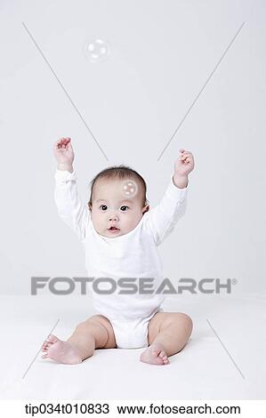 a baby and bubbles in the air View Large Photo Image Stock Image - a baby and bubbles in the air . Fotosearch