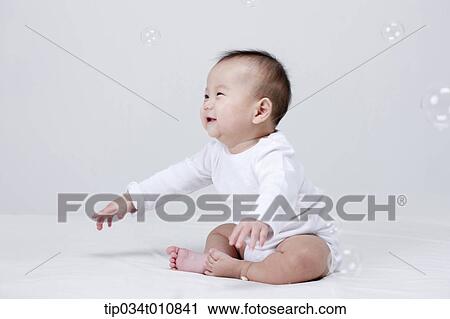 a baby and bubbles in the air View Large Photo Image Stock Image - a baby and bubbles in the air . Fotosearch