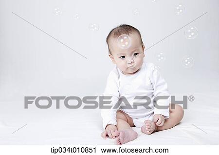 a baby and bubbles in the air View Large Photo Image Stock Image - a baby and bubbles in the air . Fotosearch