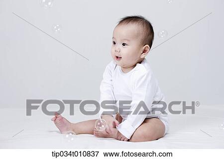 a baby and bubbles in the air View Large Photo Image Stock Photo - a baby and bubbles in the air . Fotosearch