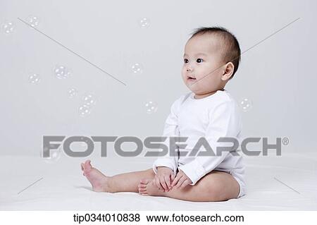 a baby and bubbles in the air View Large Photo Image Stock Photo - a baby and bubbles in the air . Fotosearch