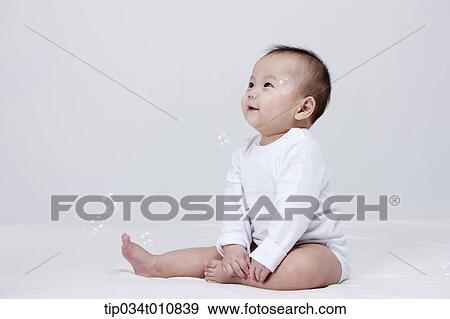 a baby and bubbles in the air View Large Photo Image Stock Photo - a baby and bubbles in the air . Fotosearch