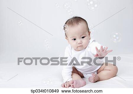 a baby and bubbles in the air View Large Photo Image Stock Photo - a baby and bubbles in the air . Fotosearch