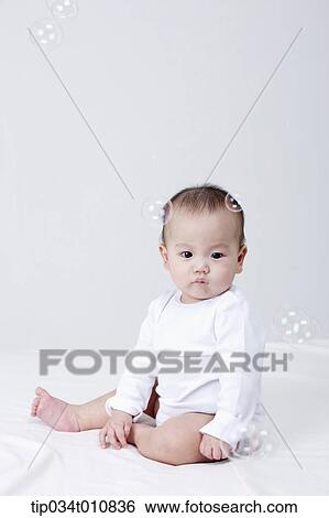 a baby and bubbles in the air View Large Photo Image Stock Photograph - a baby and bubbles in the air . Fotosearch