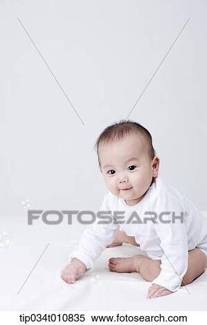a baby and bubbles in the air View Large Photo Image Stock Photography - a baby and bubbles in the air . Fotosearch