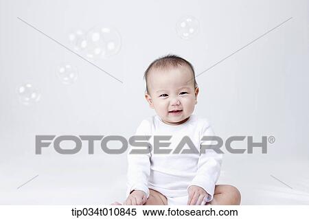 a baby and bubbles in the air View Large Photo Image Stock Photography - a baby and bubbles in the air . Fotosearch