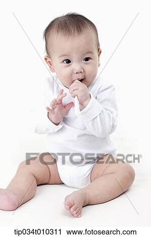 Stock Image - a baby brushing teeth. Fotosearch