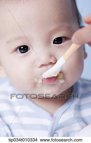 Picture - a baby having food . Fotosearch