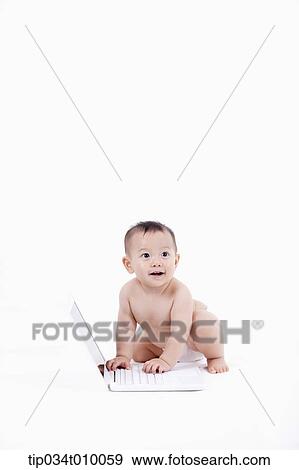 a baby in diaper playing with a laptop View Large Photo Image Stock Photo - a baby in diaper playing with a laptop. Fotosearch