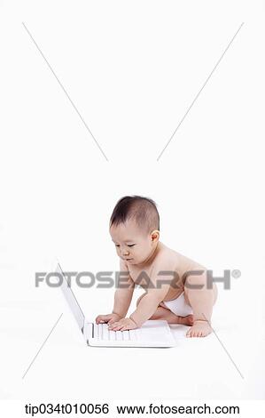 a baby in diaper playing with a laptop View Large Photo Image Stock Photograph - a baby in diaper playing with a laptop. Fotosearch
