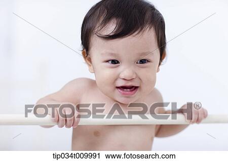 a baby in diaper standing in the crib View Large Photo Image Stock Image - a baby in diaper standing in the crib. Fotosearch