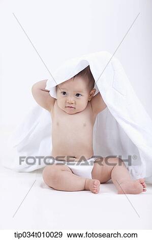Stock Photo - a baby in diaper under white blanket on white background. Fotosearch