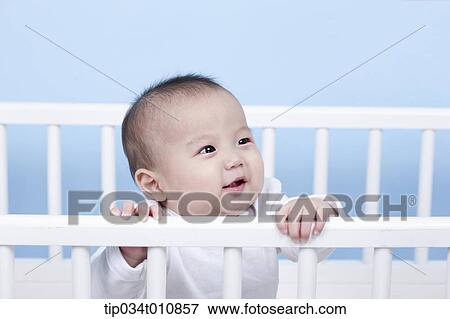 Stock Photo - a baby inside a crib. Fotosearch