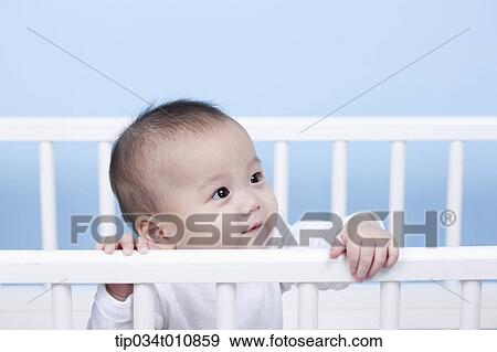 a baby inside a crib View Large Photo Image Stock Photo - a baby inside a crib. Fotosearch