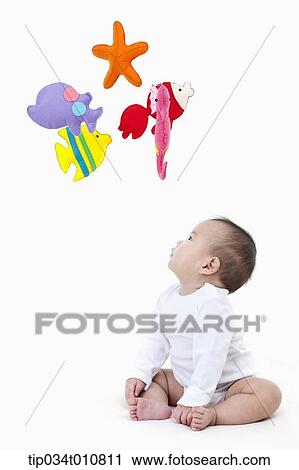 a baby looking at mobile in the ceiling View Large Photo Image Stock Image - a baby looking at mobile in the ceiling. Fotosearch