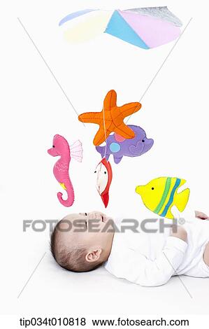 a baby looking at mobile in the ceiling View Large Photo Image Stock Photo - a baby looking at mobile in the ceiling. Fotosearch