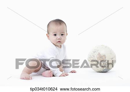 Picture - a baby playing with a globe. Fotosearch