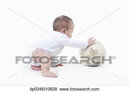 a baby playing with a globe View Large Photo Image Stock Photo - a baby playing with a globe. Fotosearch