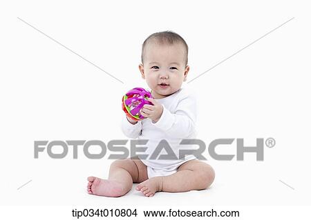Picture - a baby playing with a toy. Fotosearch