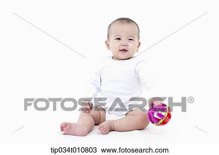 Stock Image - a baby playing with a toy. Fotosearch