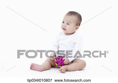 Stock Photo - a baby playing with a toy. Fotosearch