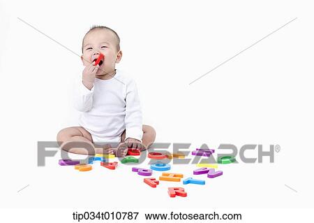 Stock Photo - a baby playing with alphabet blocks. Fotosearch
