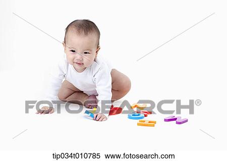 Stock Photography - a baby playing with alphabet blocks. Fotosearch