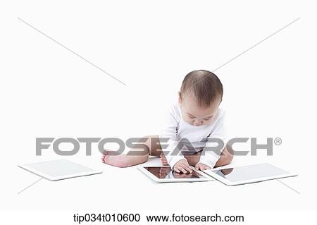 a baby playing with several tablet PCs View Large Photo Image Stock Image - a baby playing with several tablet PCs. Fotosearch