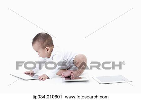 a baby playing with several tablet PCs View Large Photo Image Stock Image - a baby playing with several tablet PCs. Fotosearch