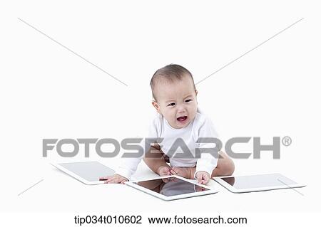 a baby playing with several tablet PCs View Large Photo Image Stock Image - a baby playing with several tablet PCs. Fotosearch