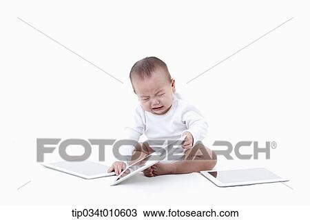 a baby playing with several tablet PCs View Large Photo Image Stock Image - a baby playing with several tablet PCs. Fotosearch