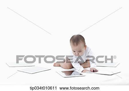 a baby playing with several tablet PCs View Large Photo Image Stock Image - a baby playing with several tablet PCs. Fotosearch