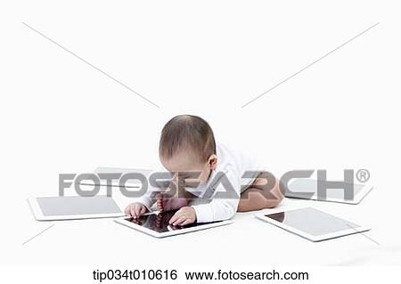a baby playing with several tablet PCs View Large Photo Image Stock Photograph - a baby playing with several tablet PCs. Fotosearch