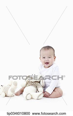 a baby with a stuffed animal toy View Large Photo Image Stock Image - a baby with a stuffed animal toy. Fotosearch