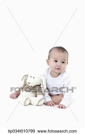 a baby with a stuffed animal toy View Large Photo Image Stock Photo - a baby with a stuffed animal toy. Fotosearch