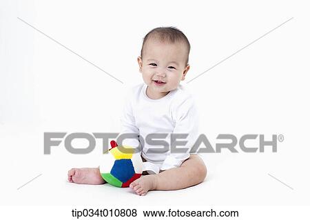 a baby with a toy ball View Large Photo Image Stock Photo - a baby with a toy ball. Fotosearch