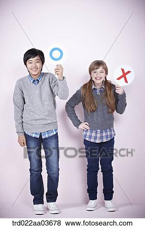 a boy and a girl each holding boards saying correct and wrong View Large Photo Image Stock Photo - a boy and a girl each holding boards saying correct and wrong. Fotosearch