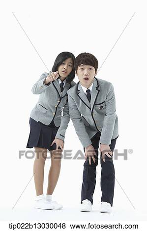 Stock Photo - a boy and a girl in school uniforms. Fotosearch