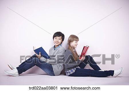a boy and a girl reading books View Large Photo Image Stock Image - a boy and a girl reading books. Fotosearch