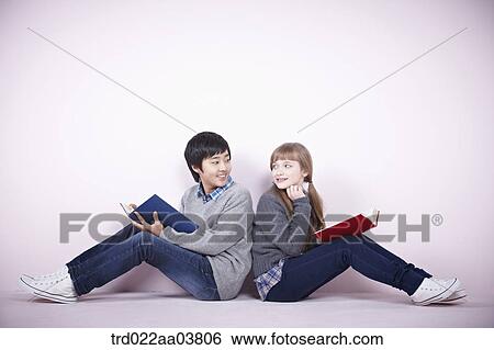 a boy and a girl reading books View Large Photo Image Stock Photograph - a boy and a girl reading books. Fotosearch