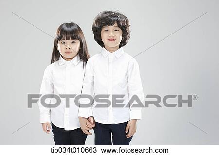 a boy and a girl standing together View Large Photo Image Stock Image - a boy and a girl standing together. Fotosearch