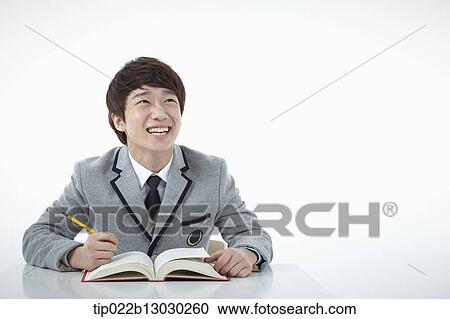 Stock Image - a boy doing homework. Fotosearch