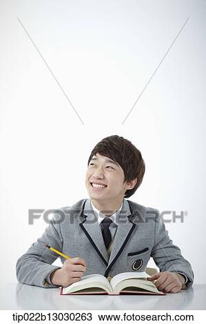 Stock Image - a boy doing homework. Fotosearch