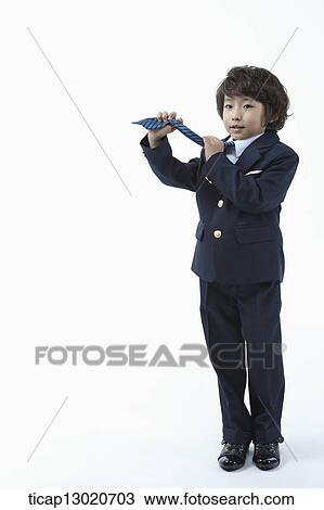 Stock Image - a boy dressed up as a business man. Fotosearch