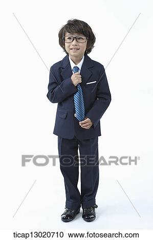 Stock Image - a boy dressed up as a business man. Fotosearch